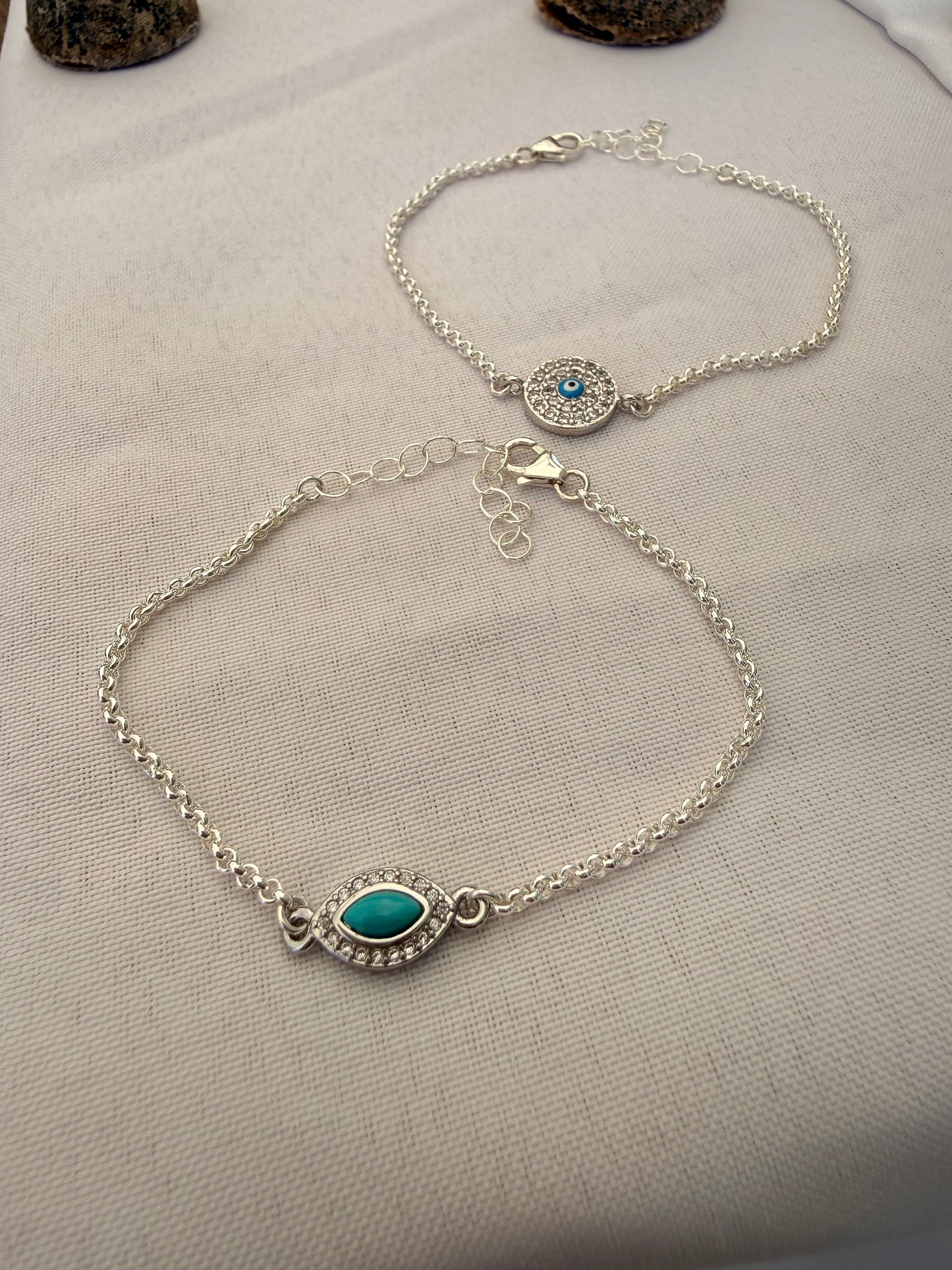 Sterling silver rolo link chain link bracelet with evil eye or clover connector