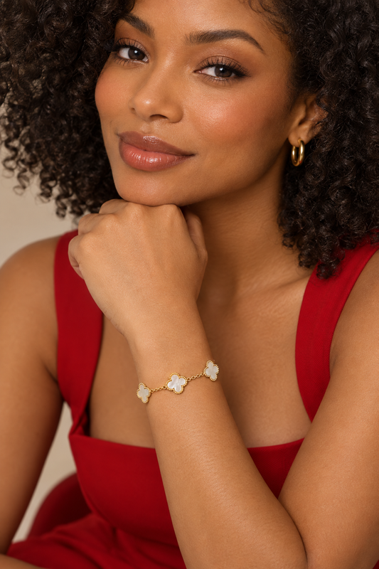 Model in a red dress wearing the mother of pearl clover bracelet